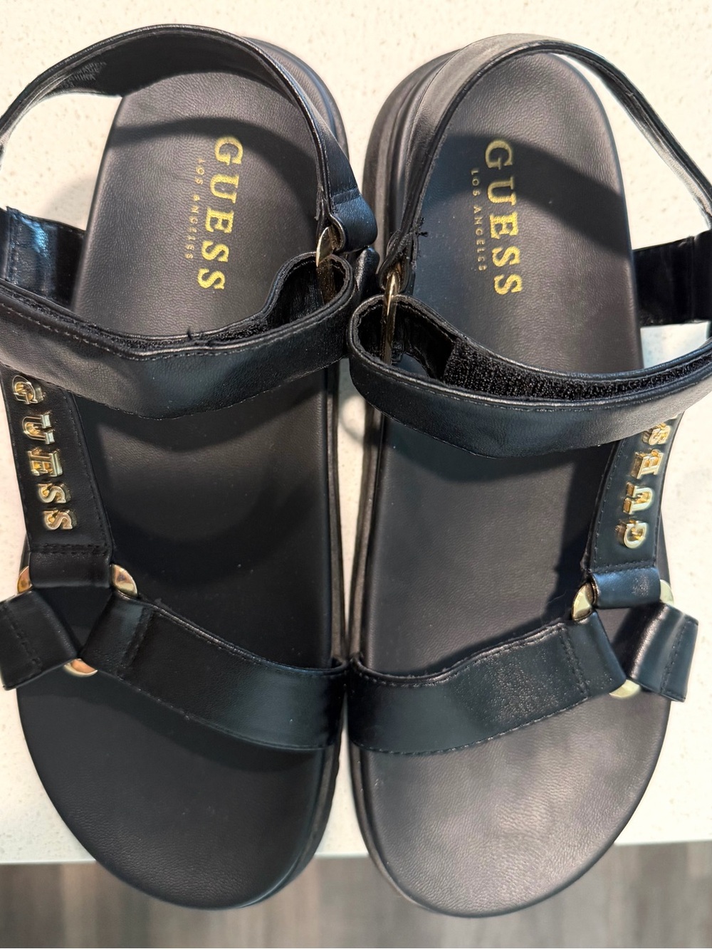GUESS Black Leather Women's Strap Sandals with Gold Logo Accents